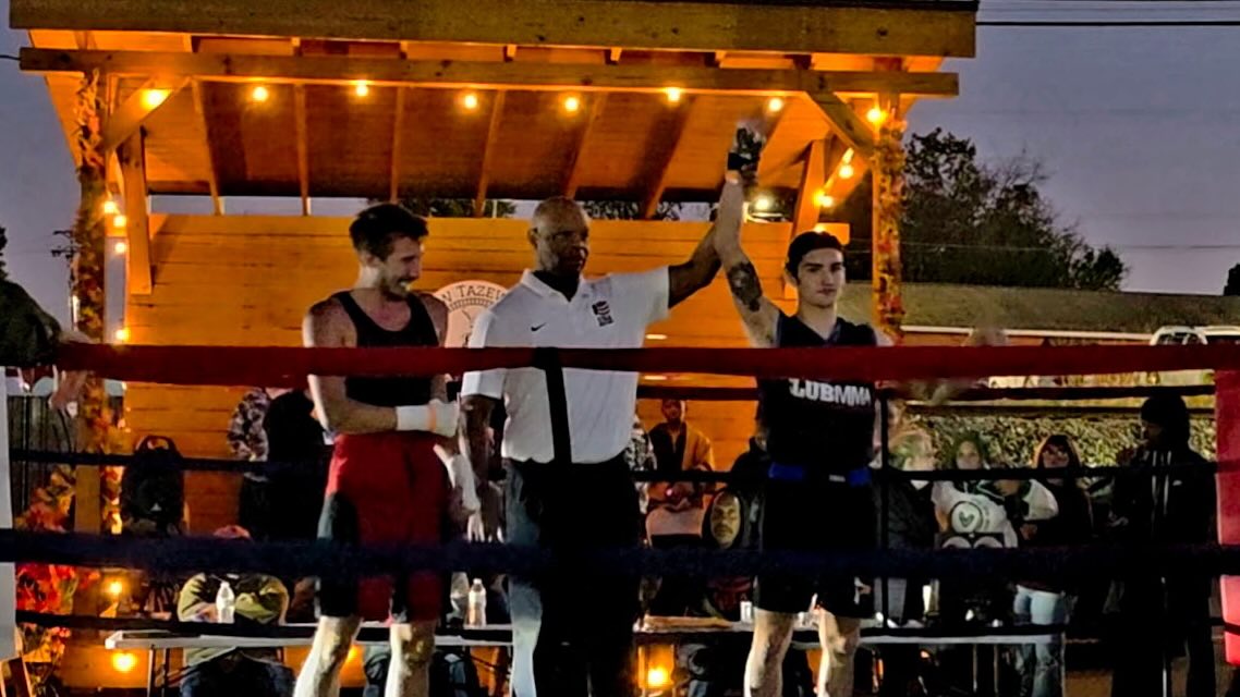 Solomon with his hand raised after a boxing match in Tennessee