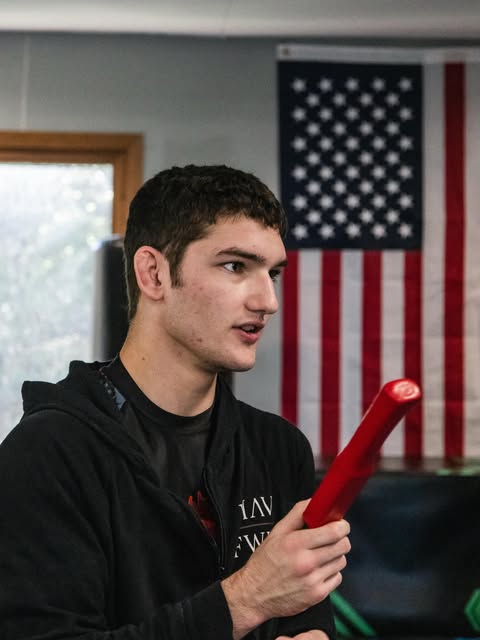 Solomon holding a red training knife during a class photo shoot at Club MMA