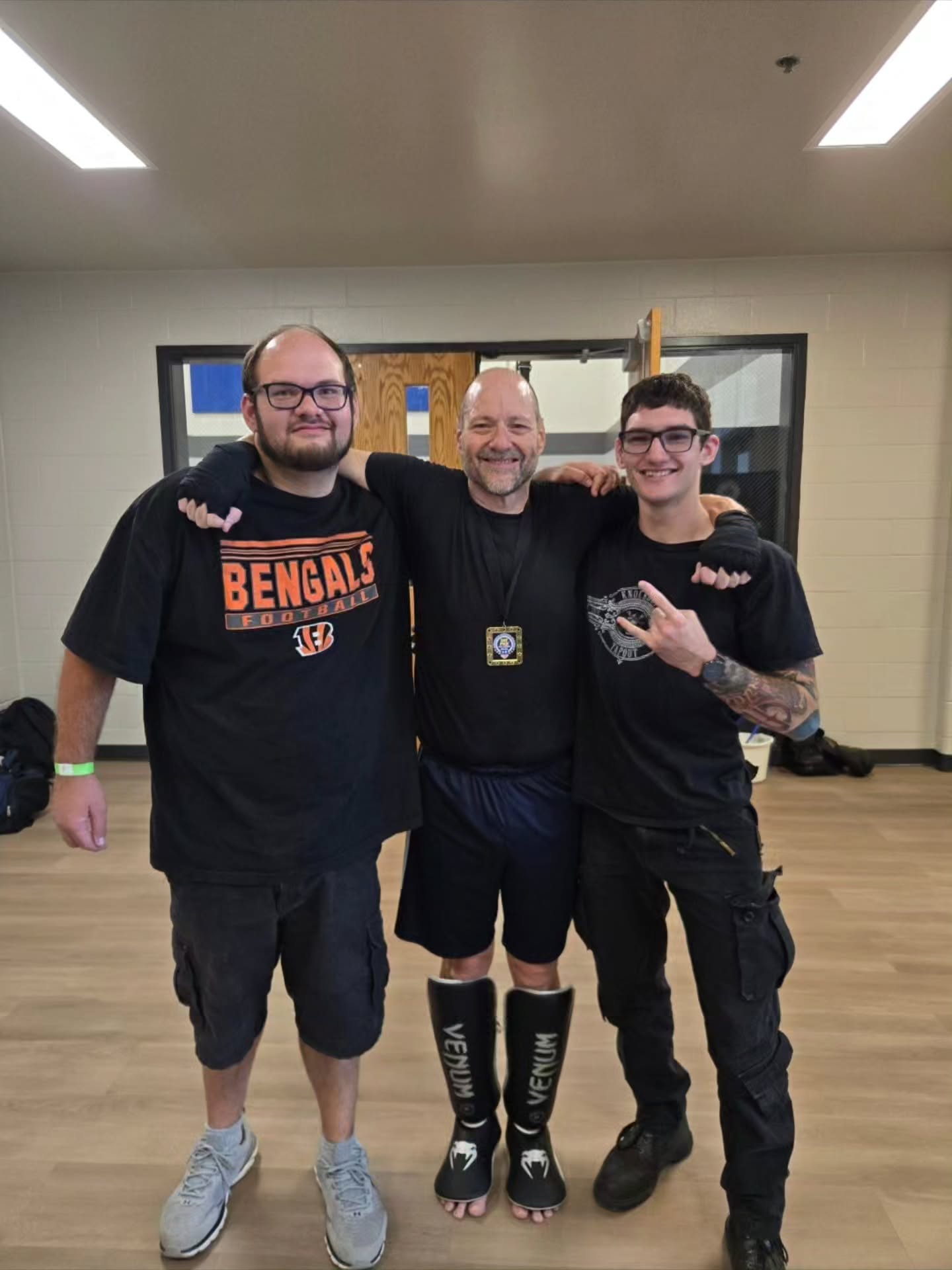 Solomon, right, with Mike Trent and a friend after a kickboxing event
