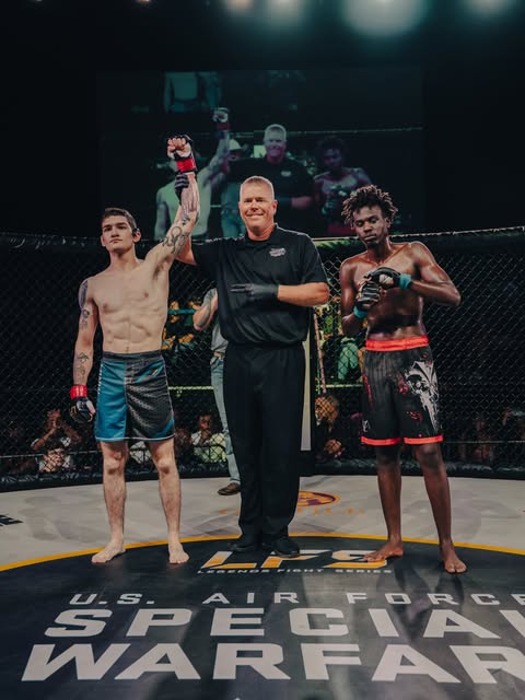Solomon, left, having his arm raised after a Legends Fight Series bout