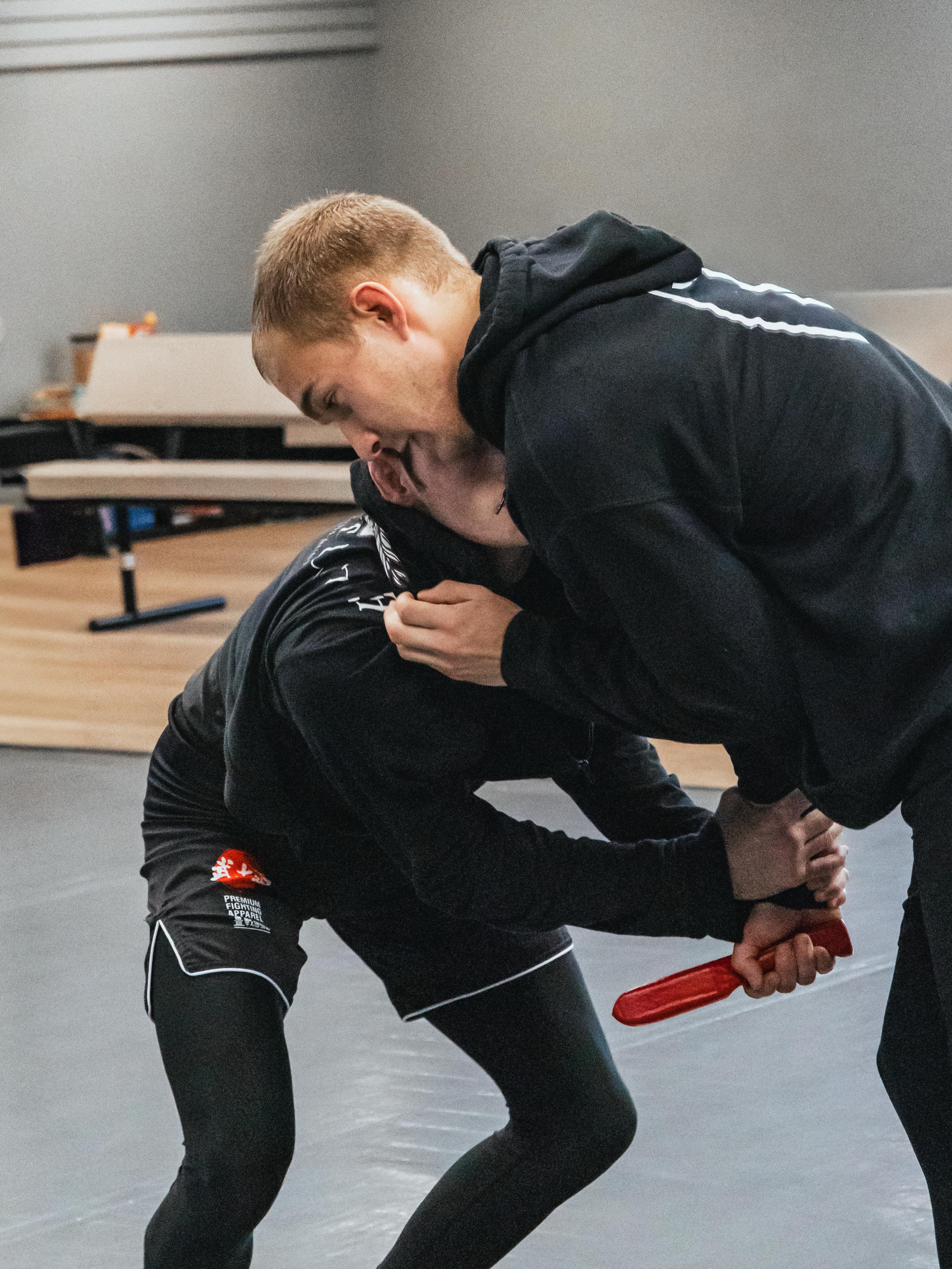 Solomon and Cole during a Kali training drill with a red training knife