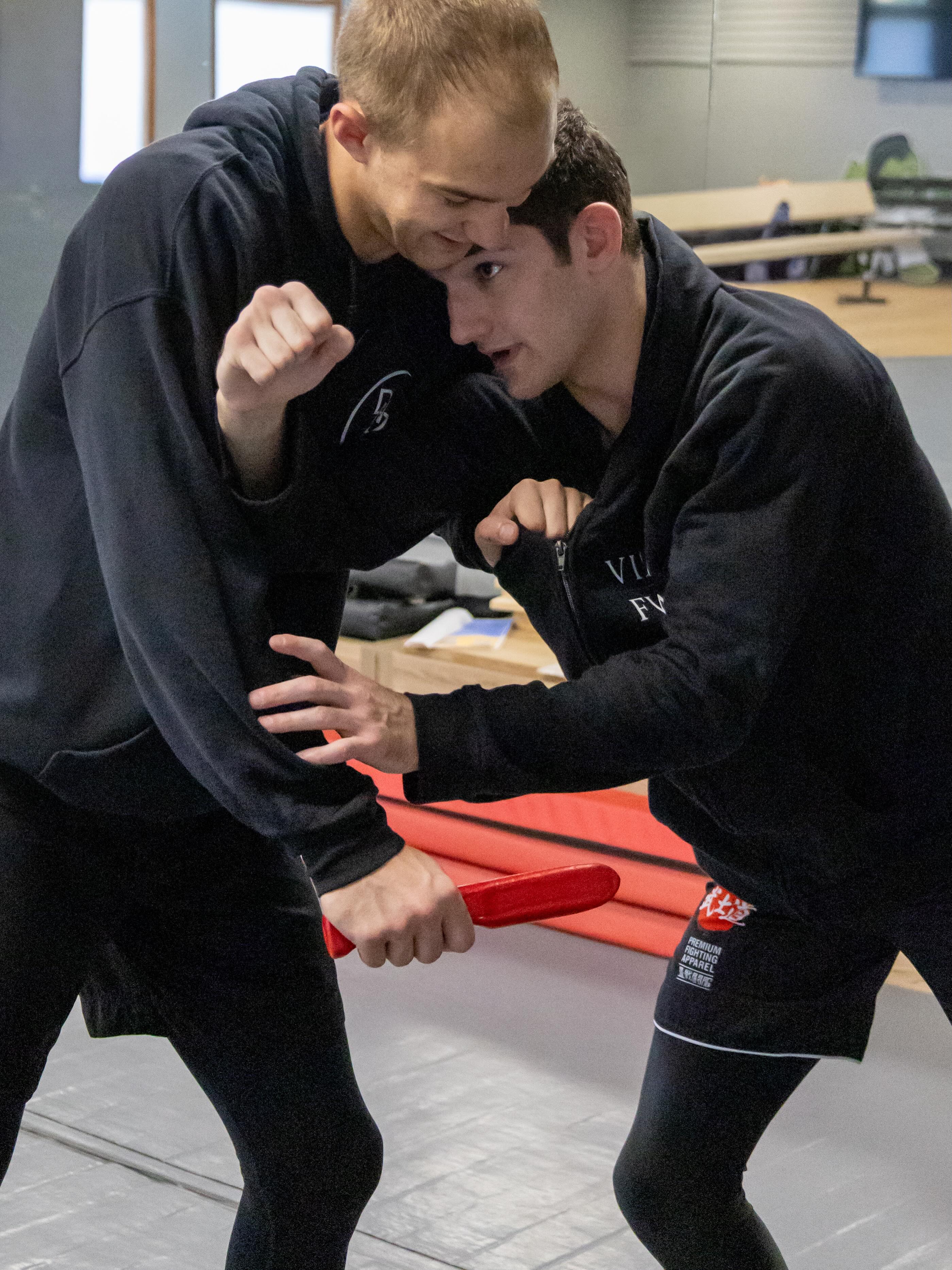 Solomon and Cole working with a red training knife at Club MMA